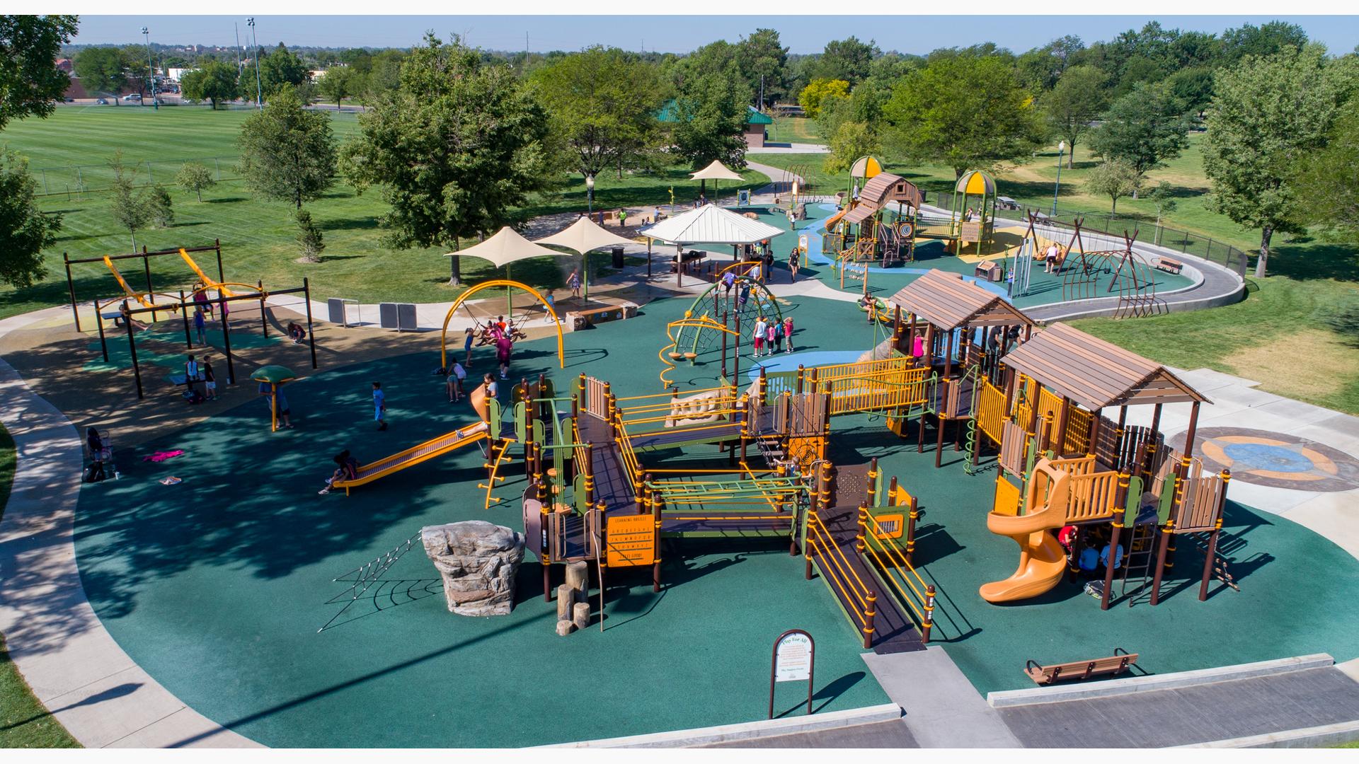 Aerial view of inclusive nature-inspired and farm-themed playground with accessible ramps. 