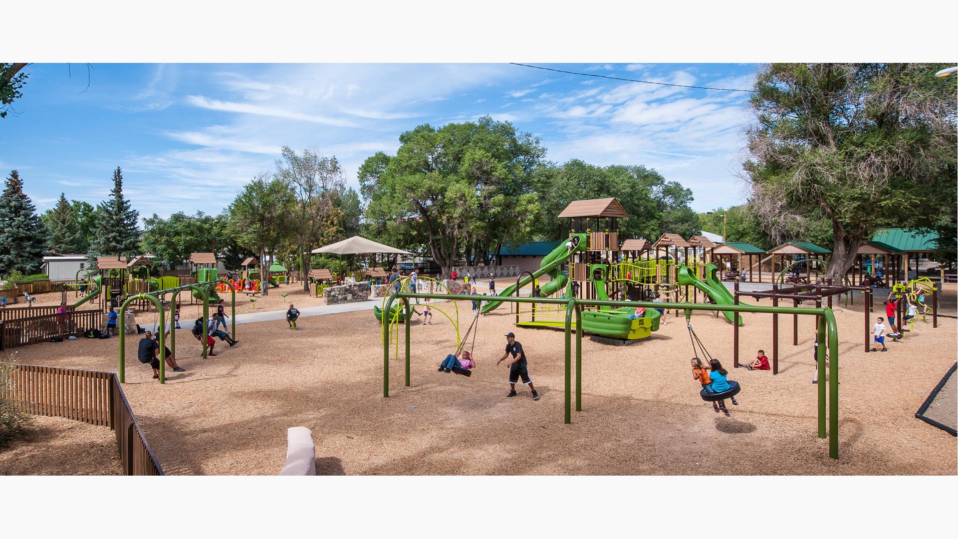 Large park in New Mexico filled with PlayBooster, Evos, Weevos, and PlayShaper play systems. Each system filled with families.