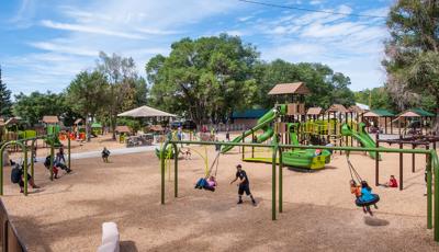 Large park in New Mexico filled with PlayBooster, Evos, Weevos, and PlayShaper play systems. Each system filled with families.