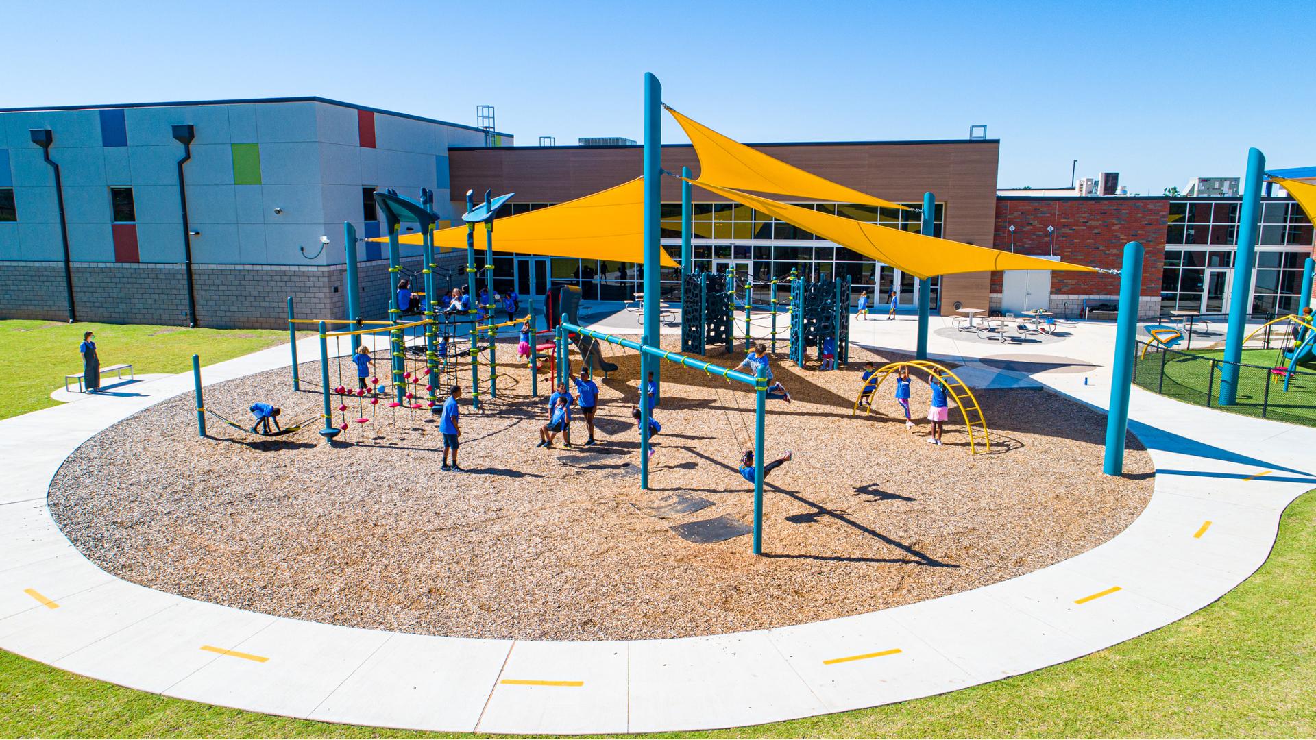 Children play on a sunny day at Positive Tomorrows playground