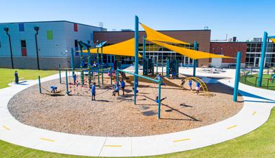 Children play on a sunny day at Positive Tomorrows playground