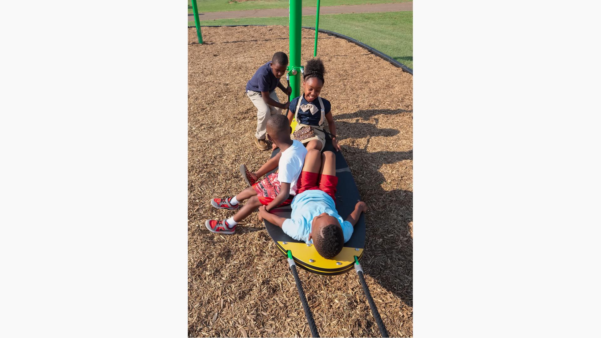 Kids laughing and sitting on Boogie Board