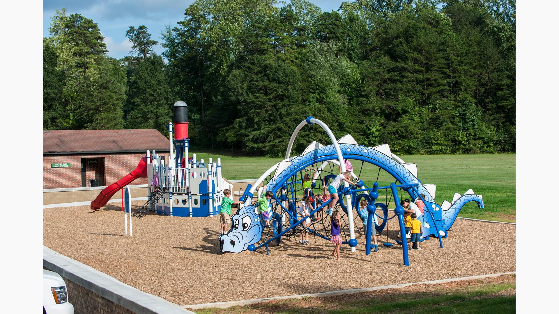 Shaffner Park with custom Evos Dragon and Steamboat play systems. The Dragon play system is crowed with kids.