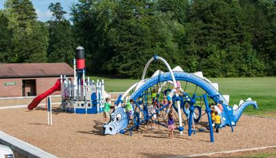 Shaffner Park with custom Evos Dragon and Steamboat play systems. The Dragon play system is crowed with kids.