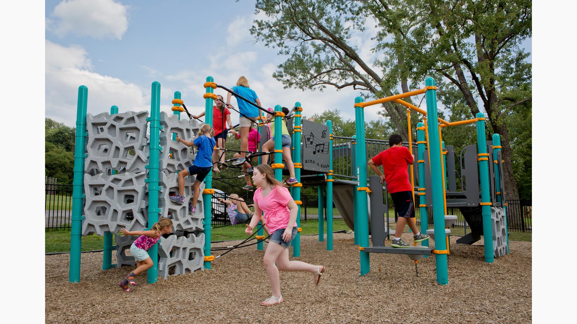 Children playing on main play structure at Baden Academy Charter School