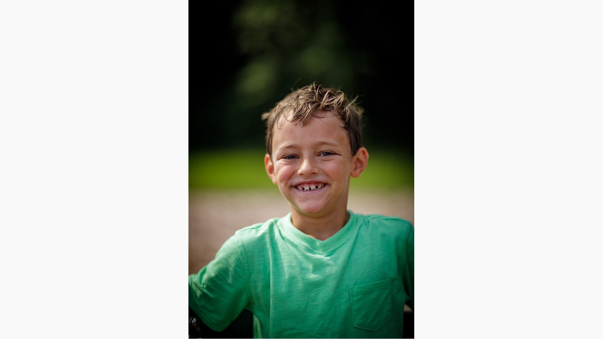 Boy in green shirt smiling