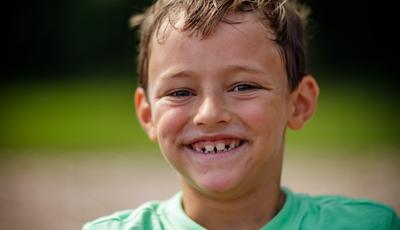 Boy in green shirt smiling